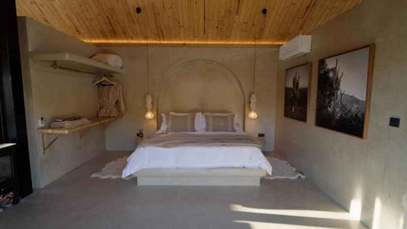 Bedroom with screeded floors and hanging pendant lights