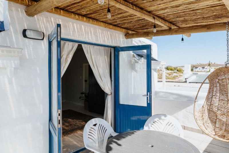 Outdoor patio from bedroom with hanging egg chair